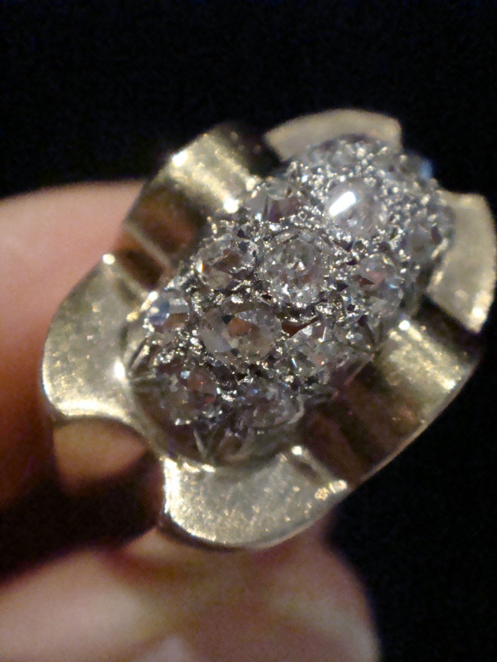 A French Retro Tank ring crafted in gold and platinum with a central pave-set diamond cluster. View VII