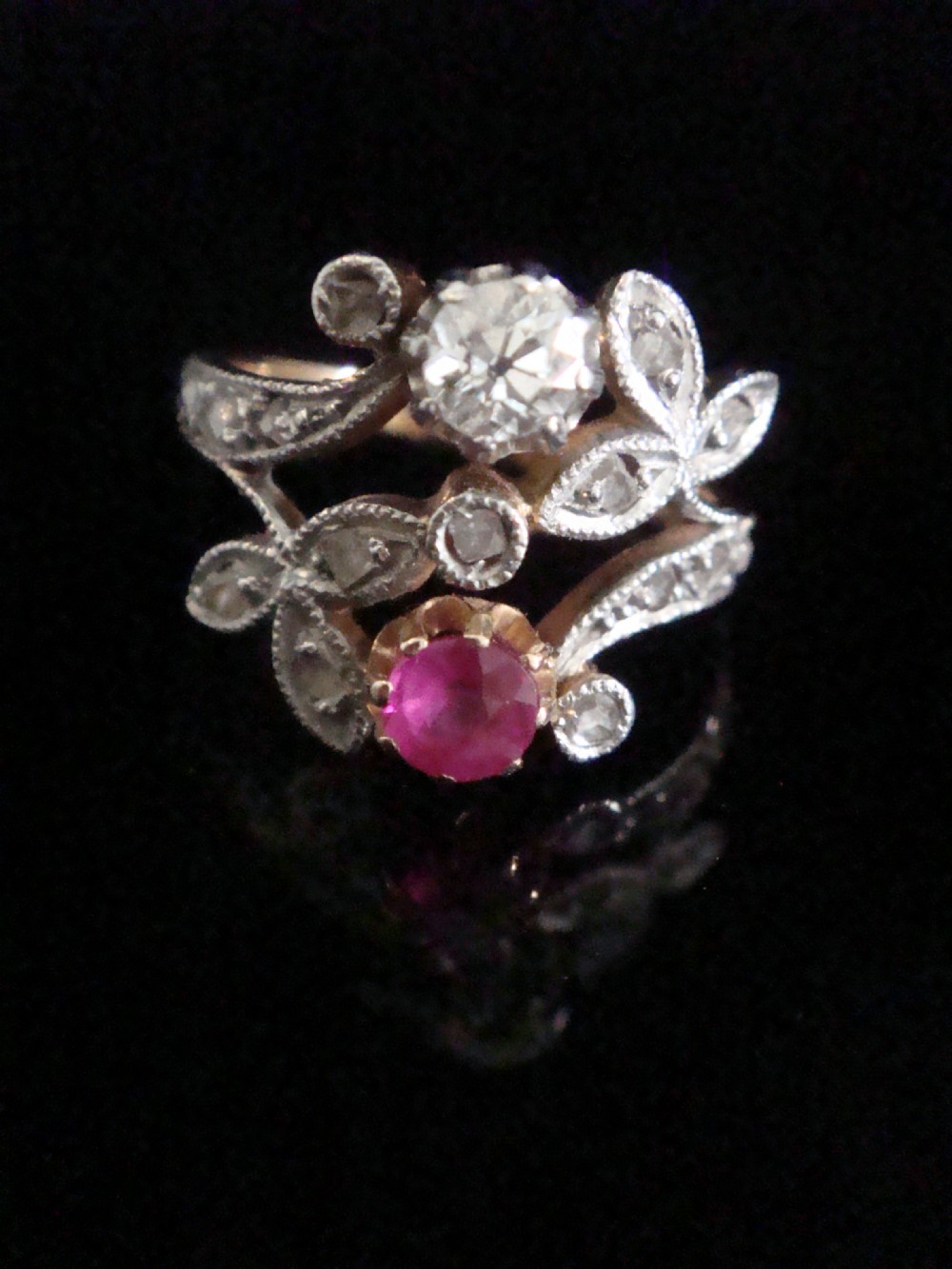 An 18ct gold Retro Modern tank ring featuring geometric diamond shoulders and a channel of calibre-cut red rubies. View XII