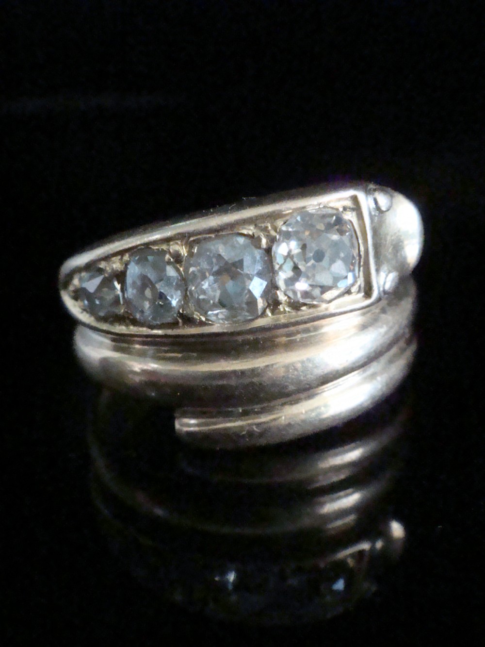 An 18ct gold Victorian coiled serpent ring set with a row of graduated old cut diamonds across the head. View II
