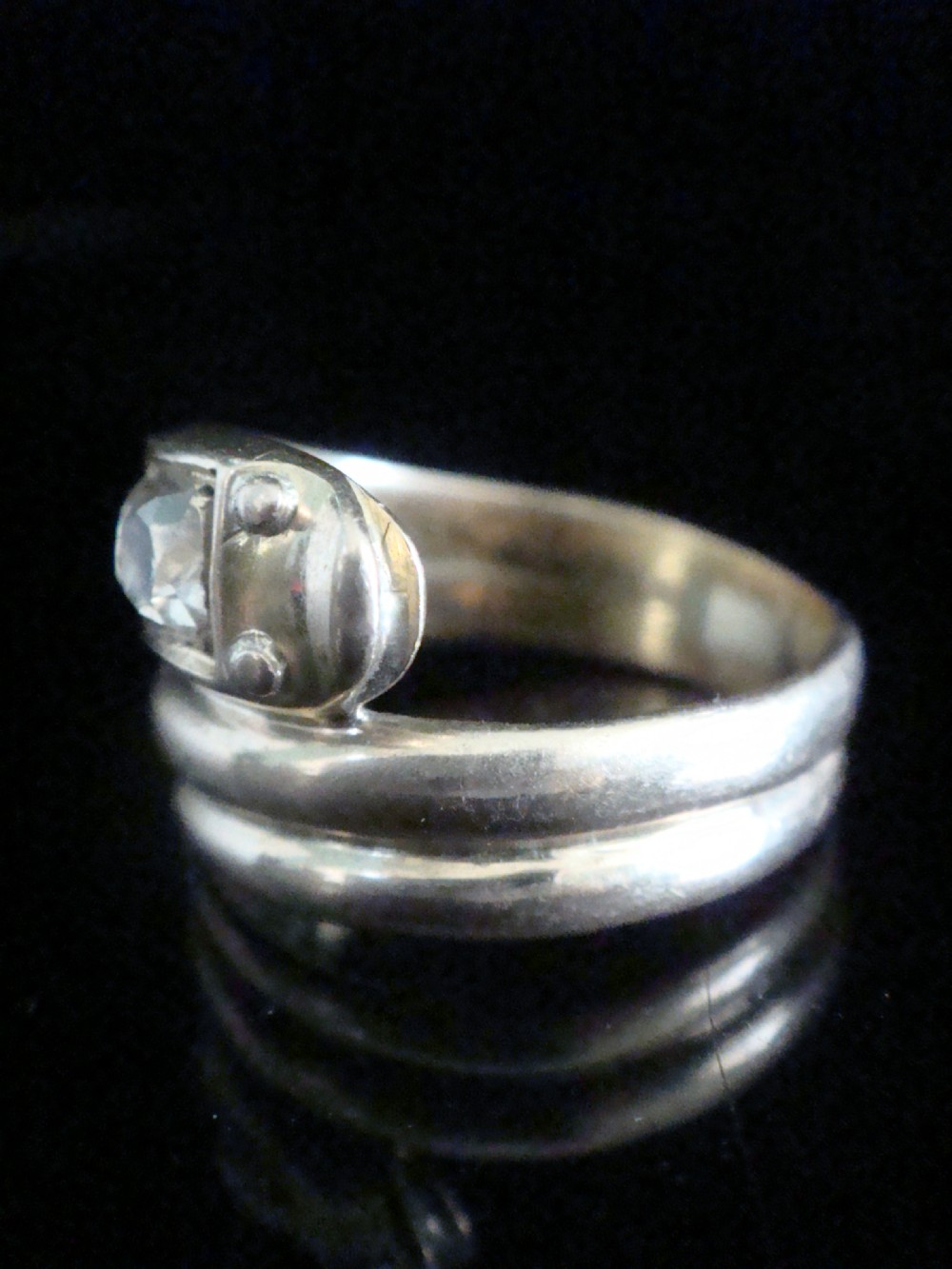 An 18ct gold Victorian coiled serpent ring set with a row of graduated old cut diamonds across the head. View III