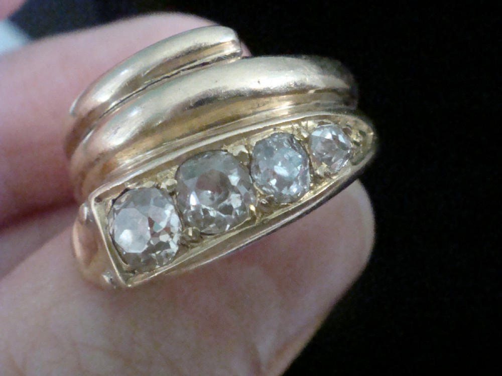 An 18ct gold Victorian coiled serpent ring set with a row of graduated old cut diamonds across the head. View IV