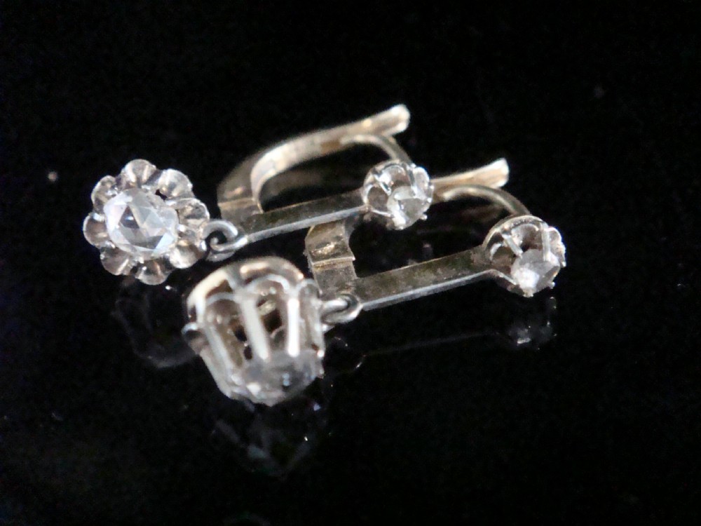 Pair of Edwardian 18ct yellow gold drop earrings featuring rose cut and old cut diamond settings with leverback fittings.
