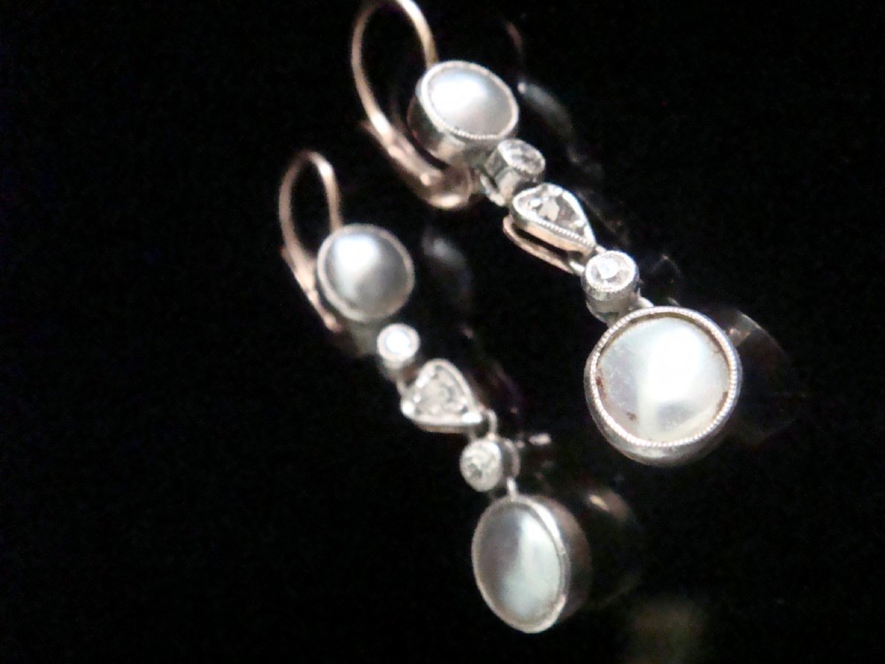 A pair of Edwardian rose gold drop earrings set with grey pearls and rose-cut diamonds, featuring a heart-shaped motif.