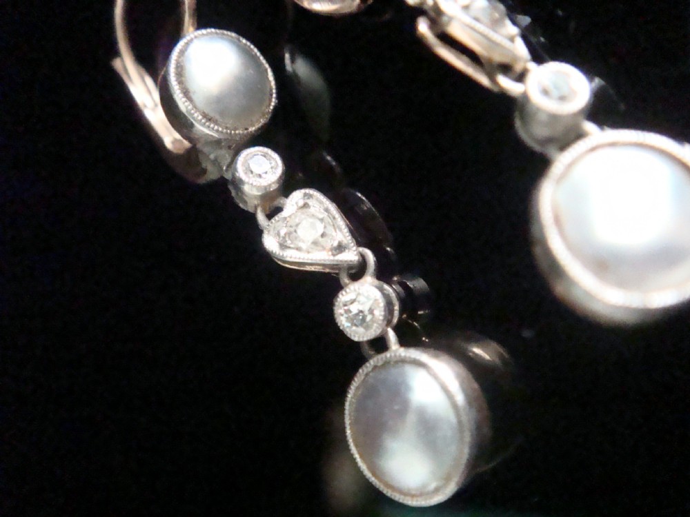 A pair of Edwardian rose gold drop earrings set with grey pearls and rose-cut diamonds, featuring a heart-shaped motif. View III