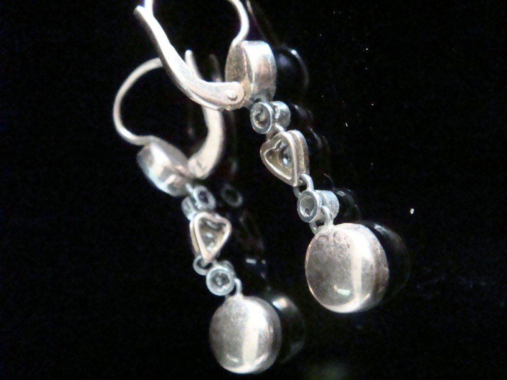 A pair of Edwardian rose gold drop earrings set with grey pearls and rose-cut diamonds, featuring a heart-shaped motif. View IV