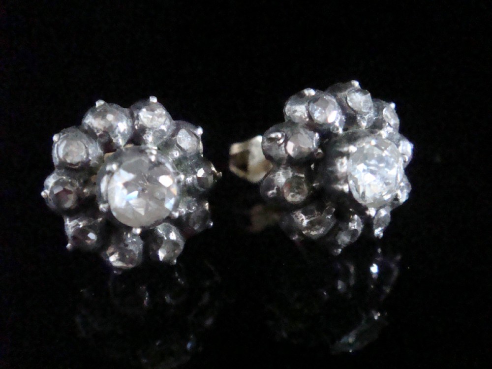 A pair of Victorian 18ct gold stud earrings featuring rose cut diamonds arranged in a floral cluster halo pattern. View II