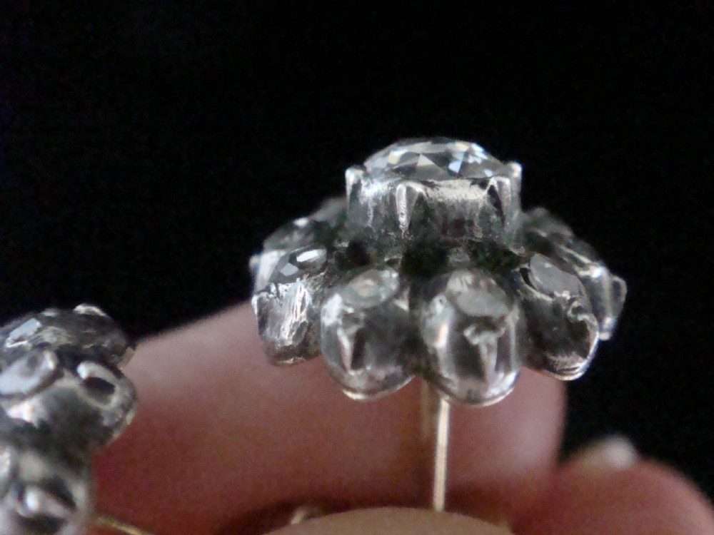 A pair of Victorian 18ct gold stud earrings featuring rose cut diamonds arranged in a floral cluster halo pattern. View IV