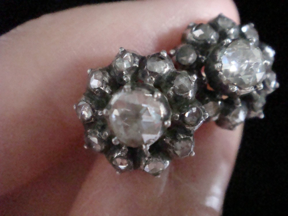 A pair of Victorian 18ct gold stud earrings featuring rose cut diamonds arranged in a floral cluster halo pattern. View V