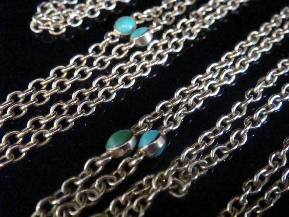An Edwardian 9ct yellow gold link longuard chain interspersed with round turquoise cabochons.