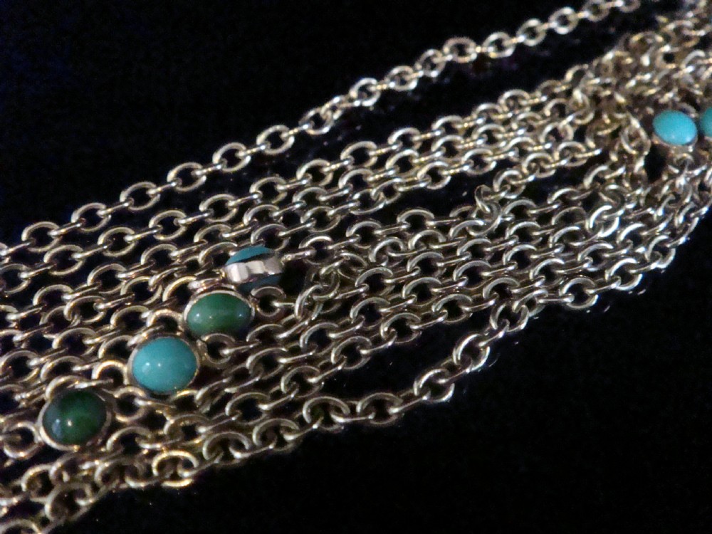 An Edwardian 9ct yellow gold link longuard chain interspersed with round turquoise cabochons. View II