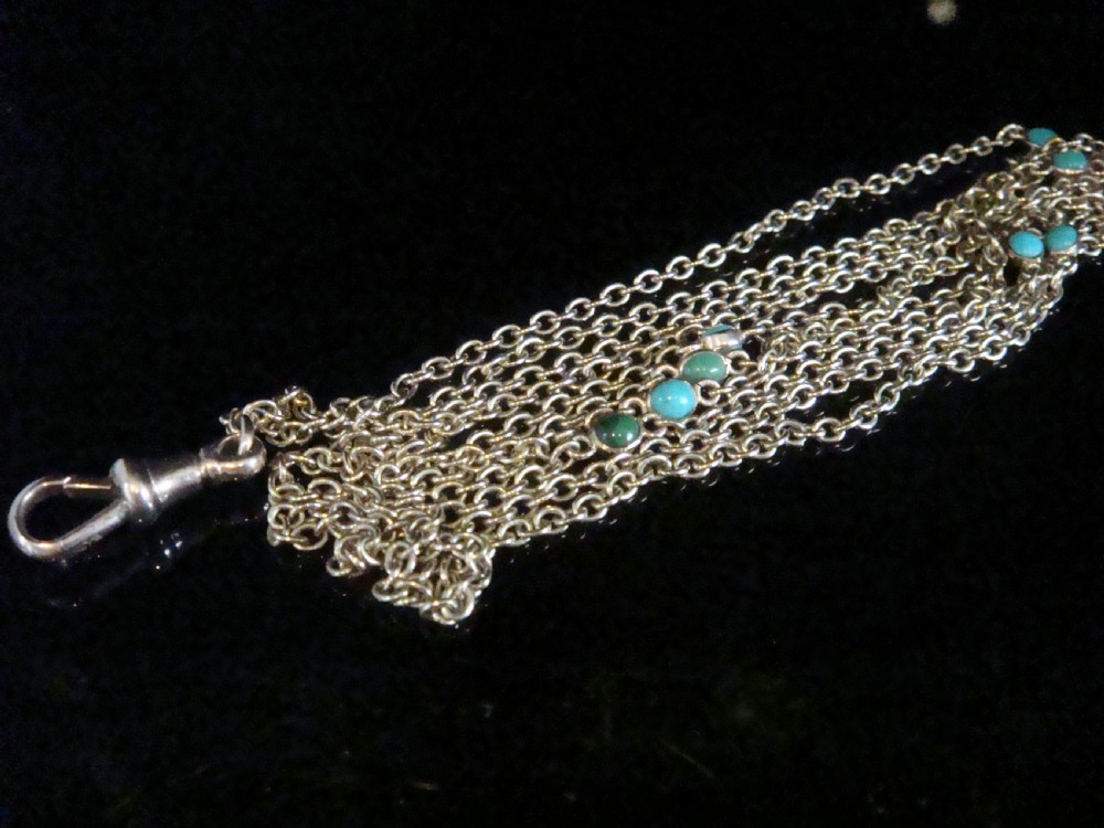 An Edwardian 9ct yellow gold link longuard chain interspersed with round turquoise cabochons. View IV