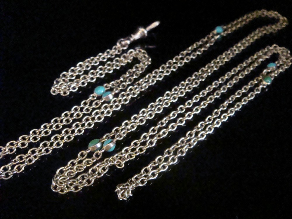 An Edwardian 9ct yellow gold link longuard chain interspersed with round turquoise cabochons. View V