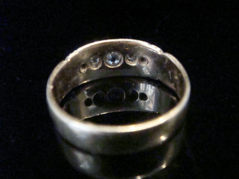 An Edwardian 18ct yellow gold band ring featuring flush-set old cut diamonds along the centre. View II