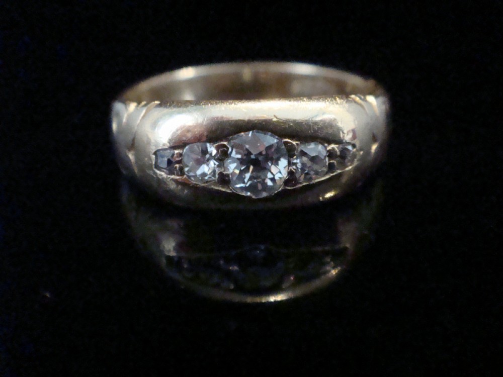 An Edwardian 18ct yellow gold band ring featuring flush-set old cut diamonds along the centre. View III