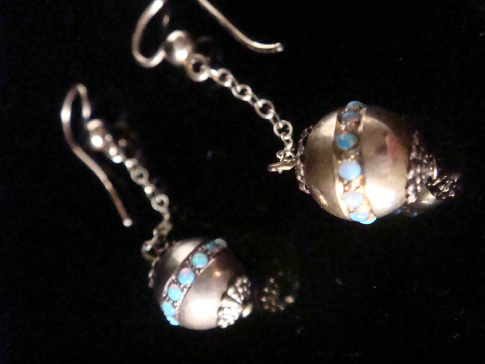 Pair of Edwardian 15ct yellow gold drop earrings with spherical pendants decorated with a central band of round natural opals.