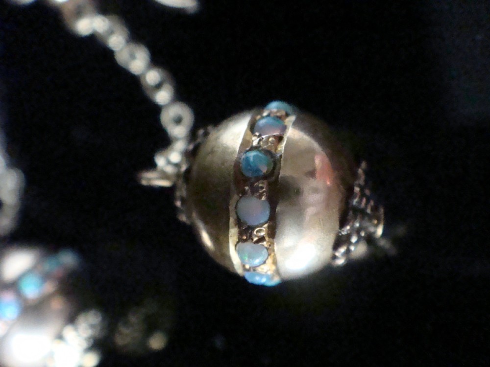 Pair of Edwardian 15ct yellow gold drop earrings with spherical pendants decorated with a central band of round natural opals. View III
