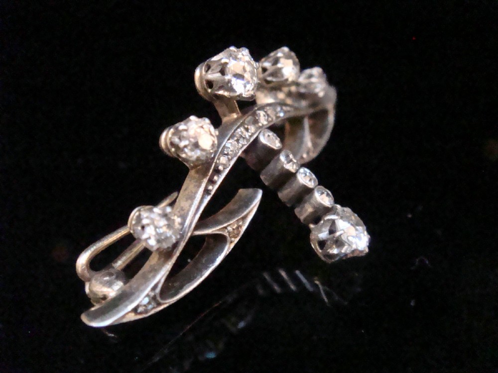 An Edwardian platinum and 18ct gold brooch designed in a tiara shape and set with old cut diamonds. View II