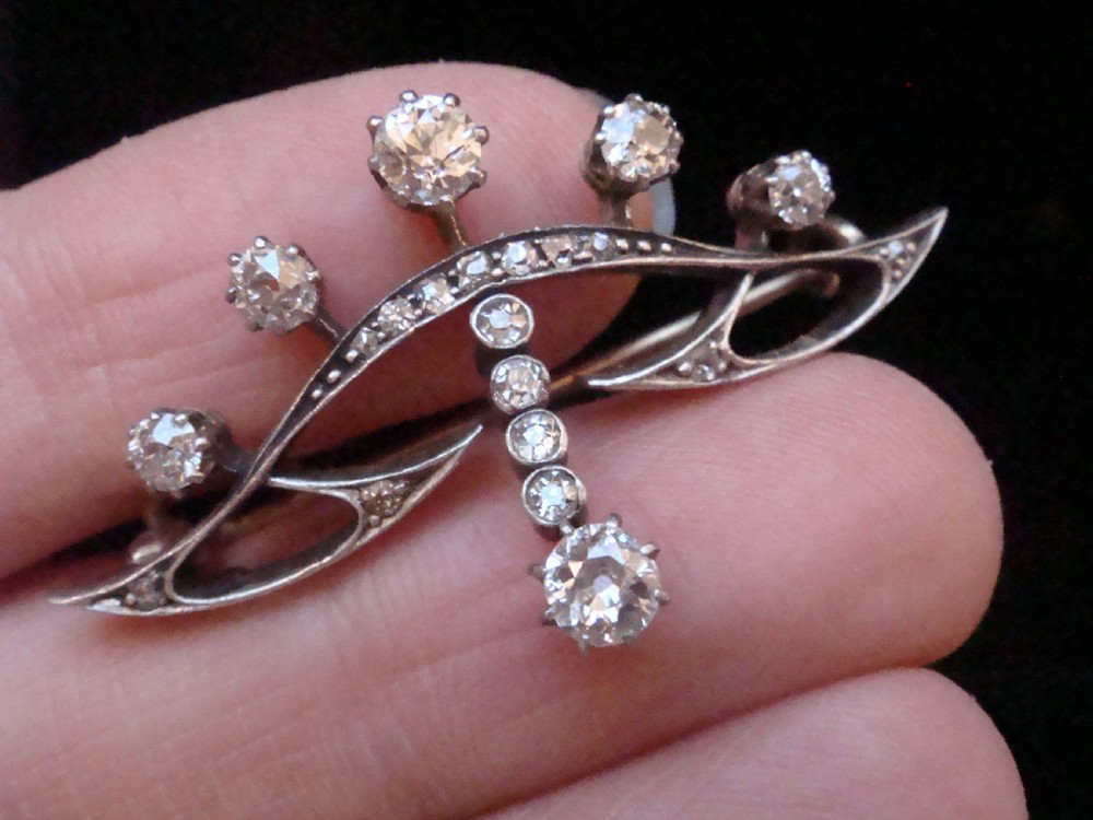 An Edwardian platinum and 18ct gold brooch designed in a tiara shape and set with old cut diamonds. View III