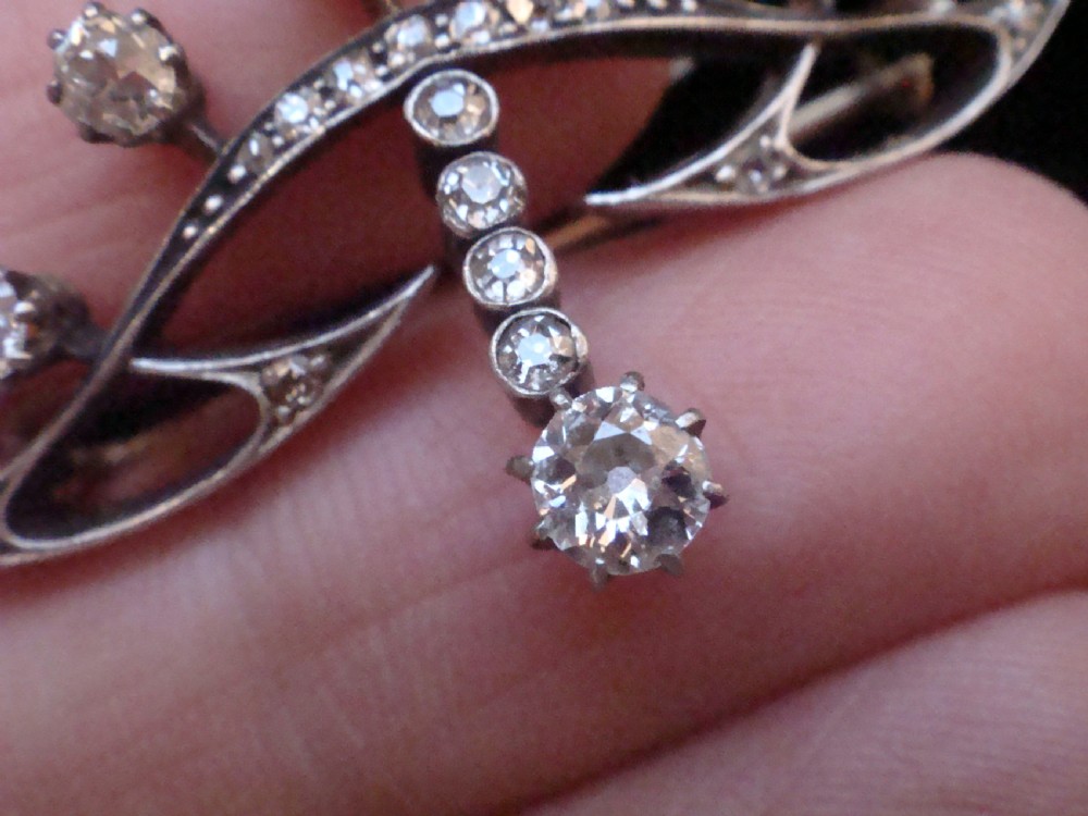 An Edwardian platinum and 18ct gold brooch designed in a tiara shape and set with old cut diamonds. View IV