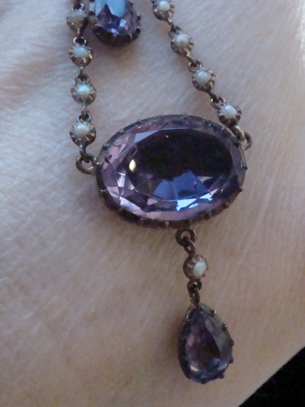 An early Victorian yellow gold lavalier pendant necklace featuring oval and teardrop cut purple amethysts bordered with natural pearls. View II
