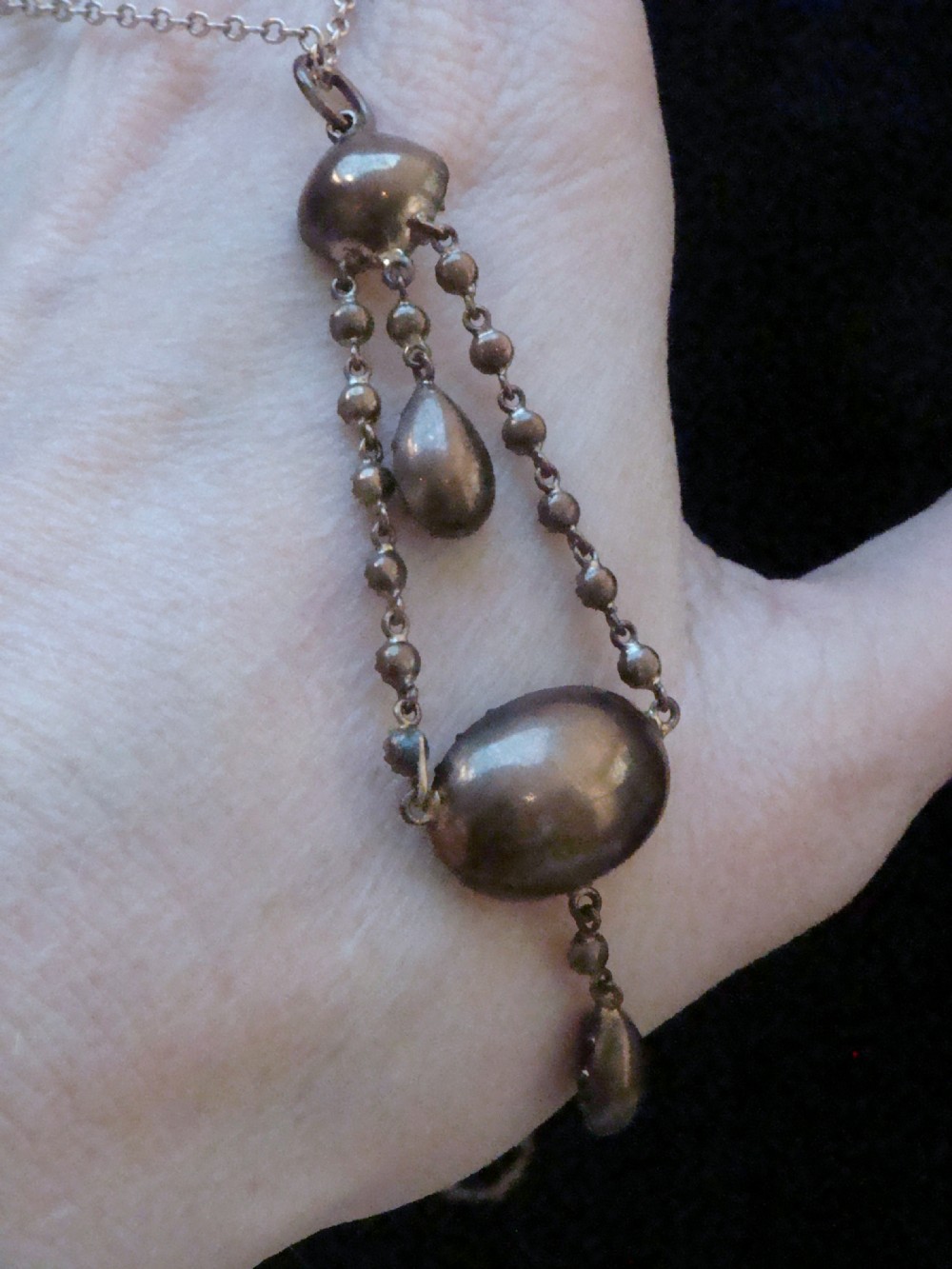 An early Victorian yellow gold lavalier pendant necklace featuring oval and teardrop cut purple amethysts bordered with natural pearls. View III