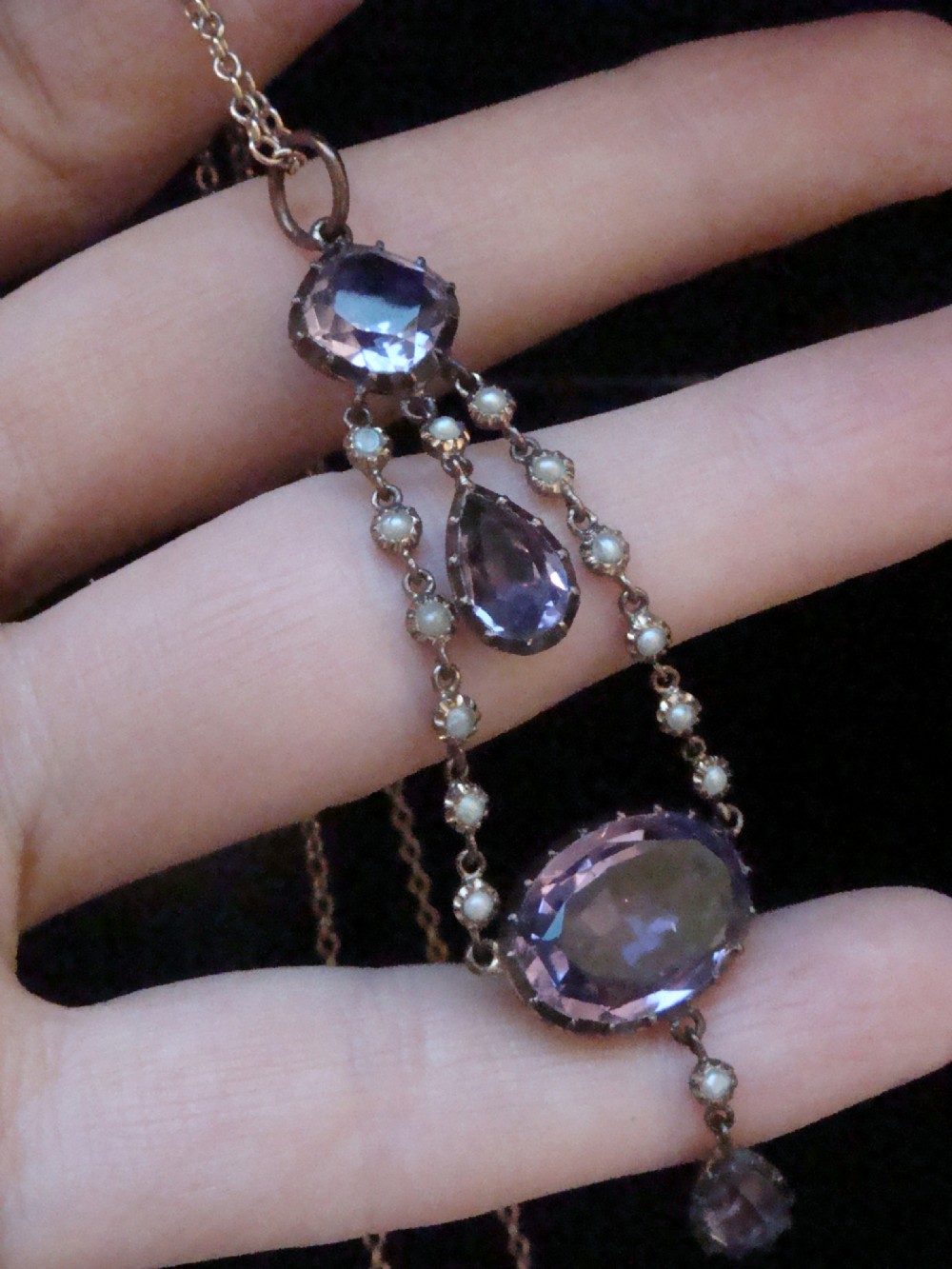 An early Victorian yellow gold lavalier pendant necklace featuring oval and teardrop cut purple amethysts bordered with natural pearls. View IV