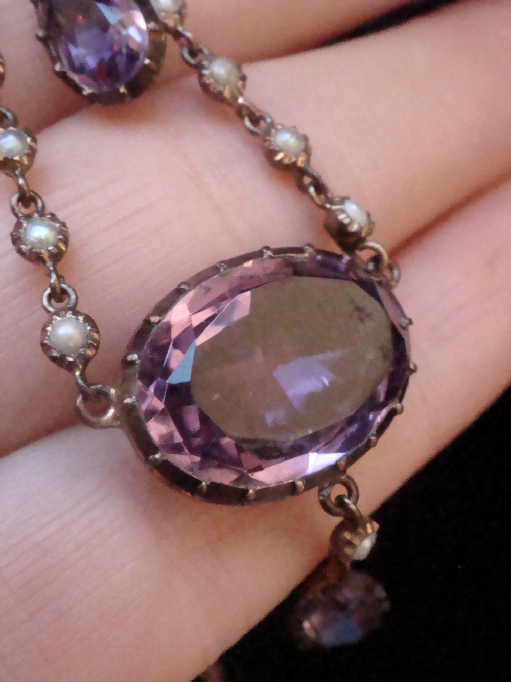 An early Victorian yellow gold lavalier pendant necklace featuring oval and teardrop cut purple amethysts bordered with natural pearls. View VI