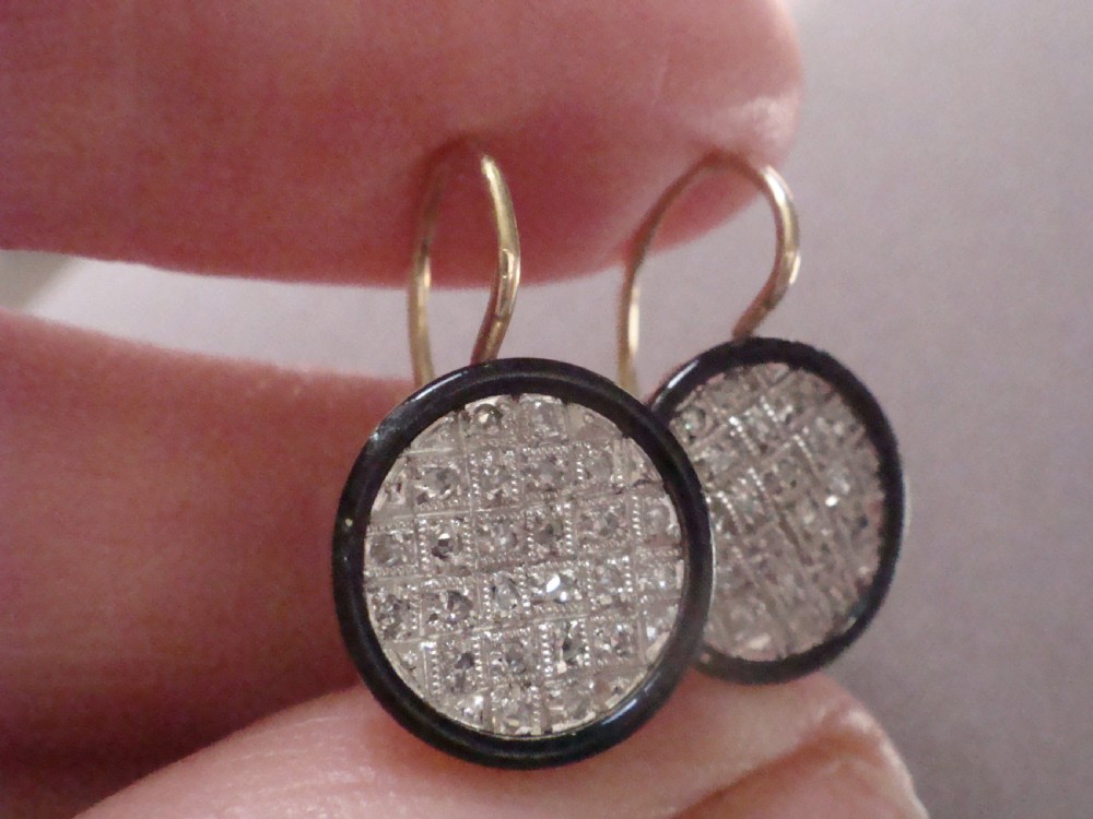 Pair of circular Edwardian drop earrings featuring pave-set diamonds surrounded by a black enamel border with wire fittings. View IV