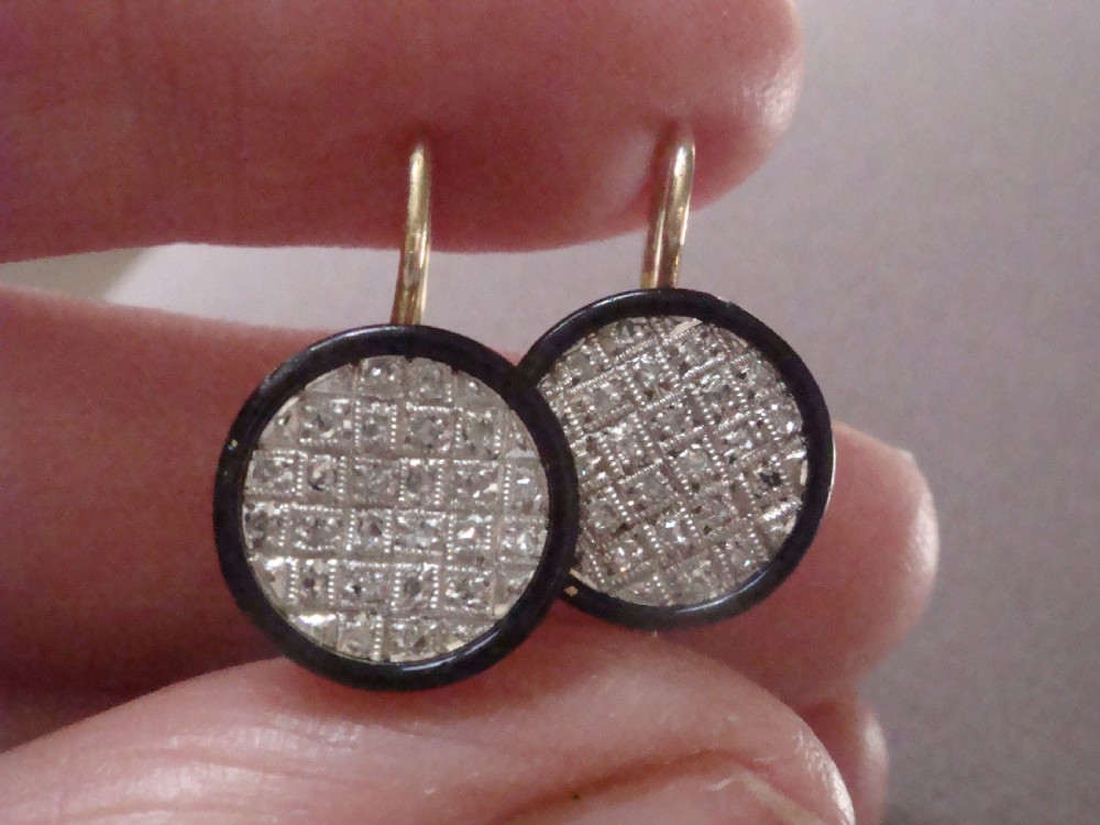 Pair of circular Edwardian drop earrings featuring pave-set diamonds surrounded by a black enamel border with wire fittings. View V