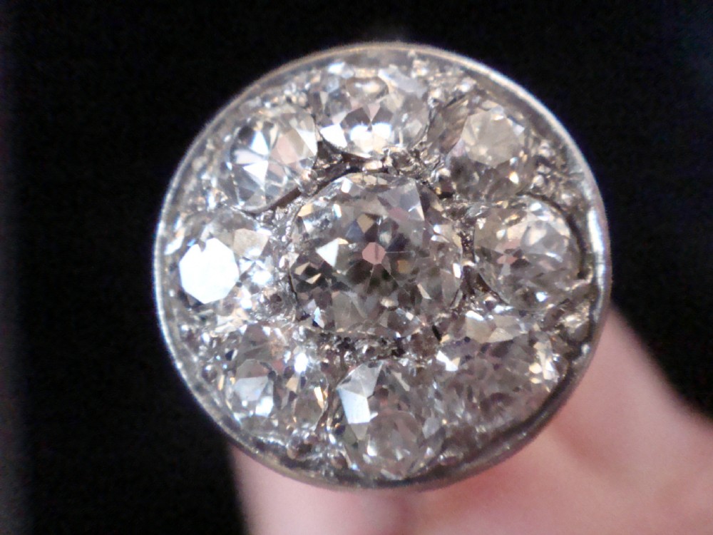 An Edwardian 18ct white gold ring featuring a circular cluster set with natural old cut diamonds. View VIII