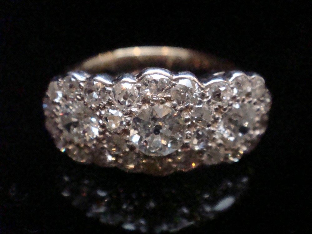 An Edwardian 18ct yellow gold and platinum cluster ring set with multiple natural old cut diamonds in an oval layout. View III