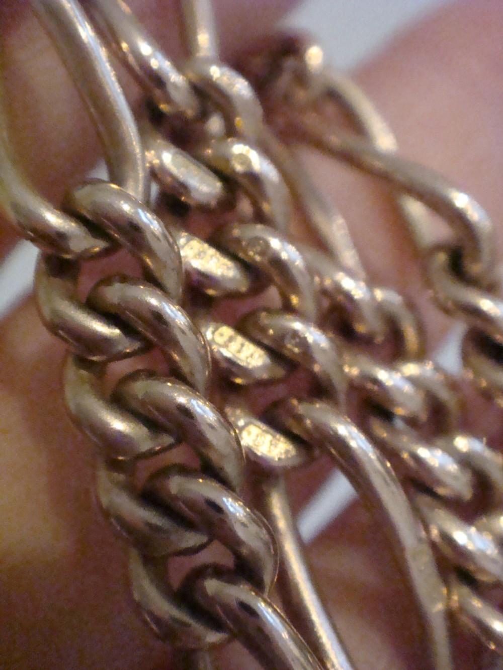 An Edwardian 9ct yellow gold Figaro link double Albert chain featuring a central T-bar, floating ring, and two dog clip fasteners. View IV