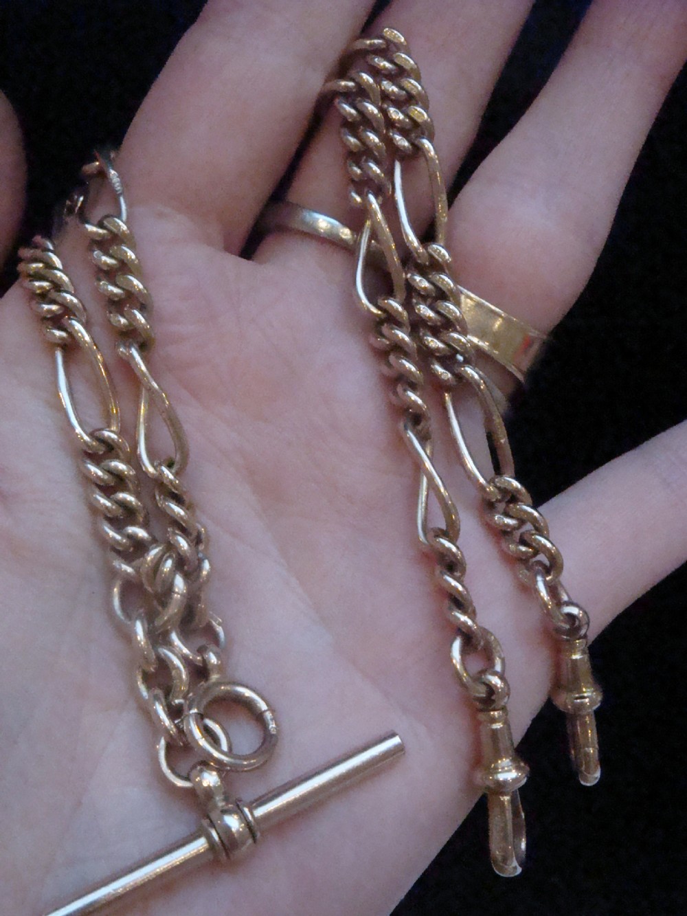 An Edwardian 9ct yellow gold Figaro link double Albert chain featuring a central T-bar, floating ring, and two dog clip fasteners. View VII