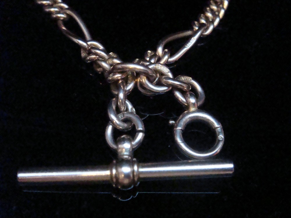 An Edwardian 9ct yellow gold Figaro link double Albert chain featuring a central T-bar, floating ring, and two dog clip fasteners. View VIII