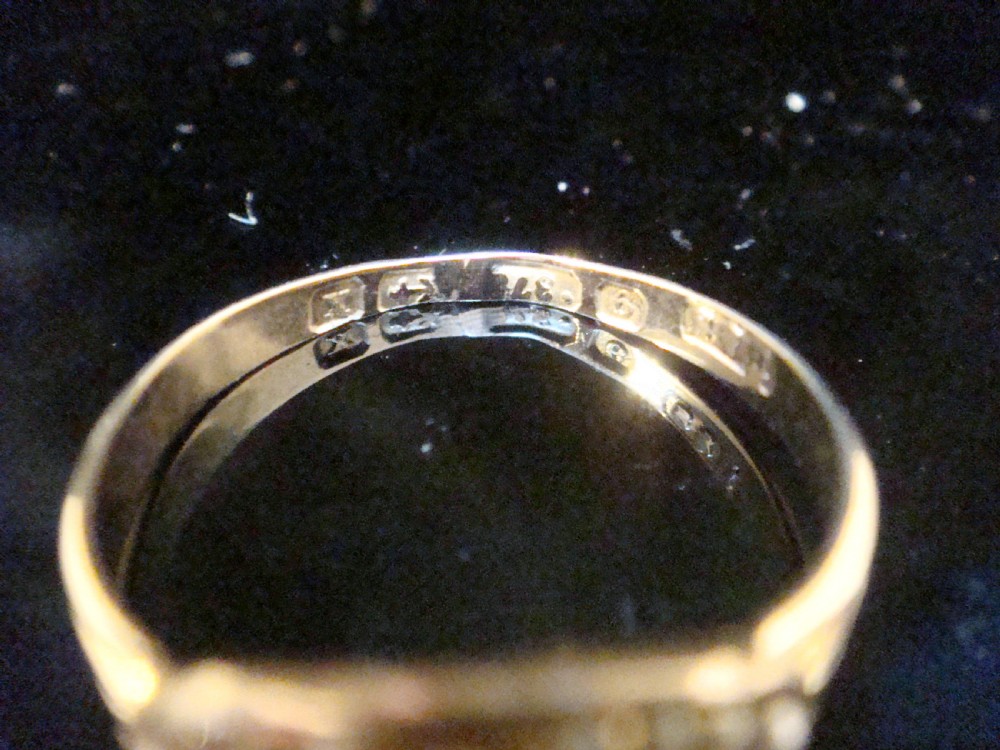 An Edwardian 9ct gold ring featuring a central eye-shaped navette motif set with turquoise cabochons and surrounded by small seed pearls. View II