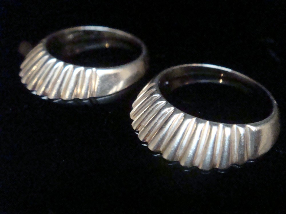 A pair of 9ct yellow gold ring enhancers featuring a fluted and ribbed texture designed to frame a central band. View III
