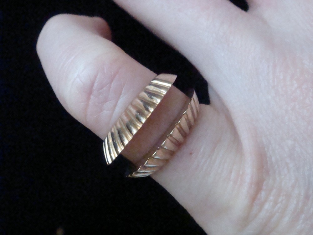 A pair of 9ct yellow gold ring enhancers featuring a fluted and ribbed texture designed to frame a central band. View IV