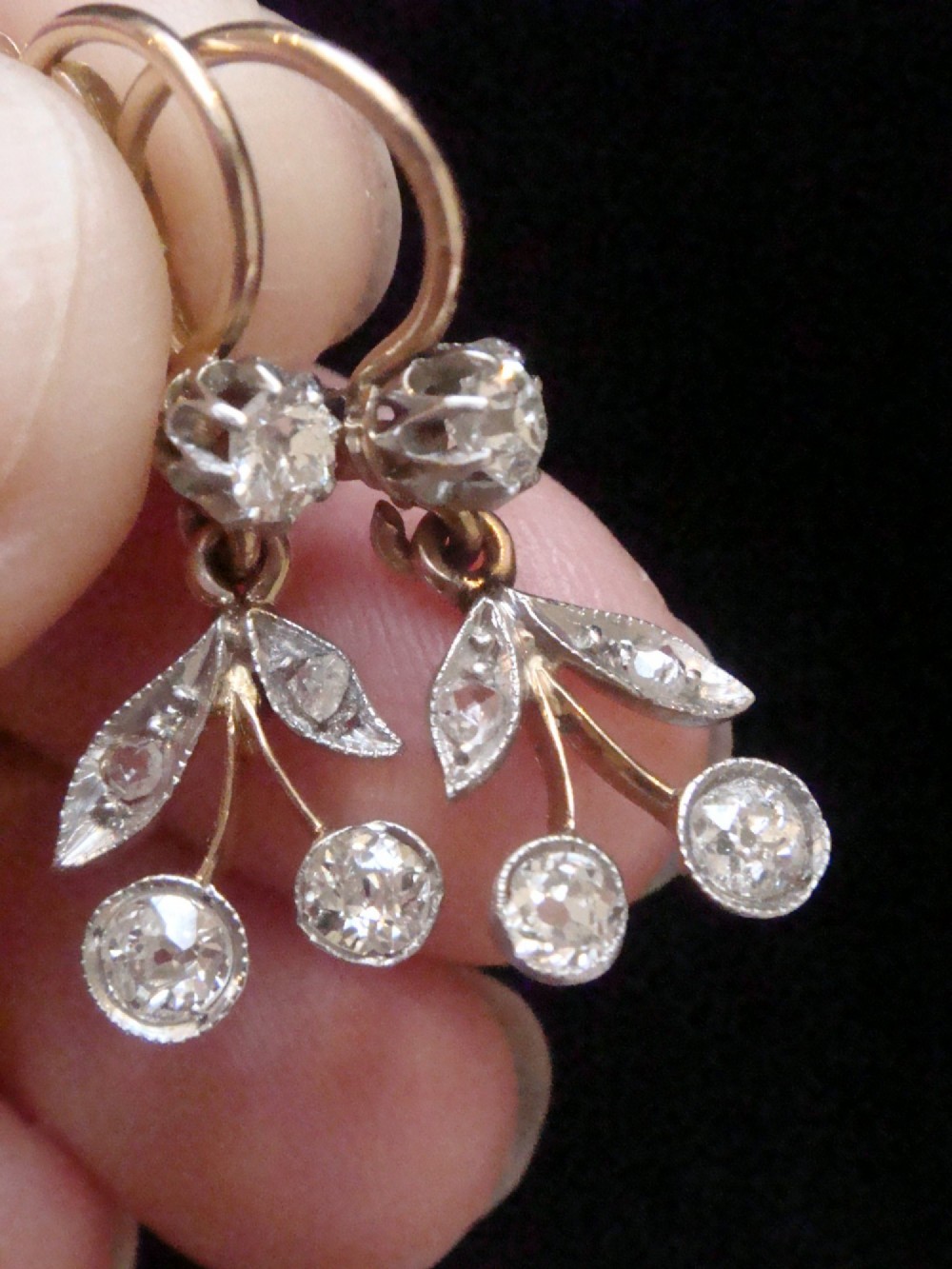 A pair of French Edwardian 18ct yellow gold drop earrings featuring a botanical leaf design set with old cut diamonds. View III