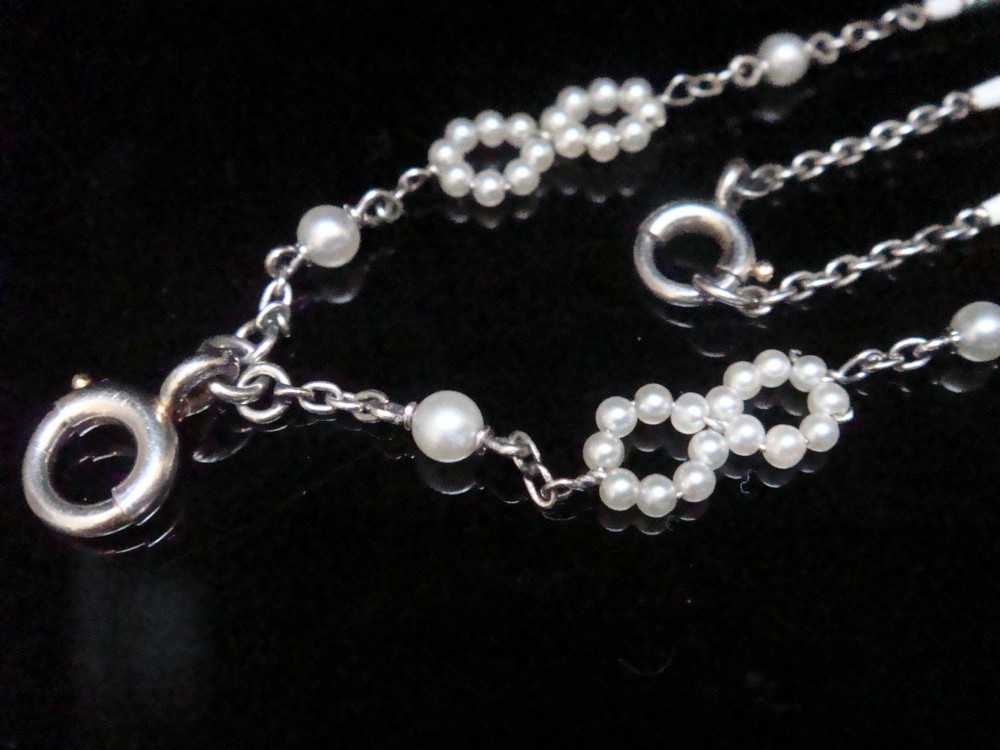 An Edwardian platinum chain detailed with small pearl clusters, single saltwater pearls, and delicate turquoise guilloche enamel links. View IV