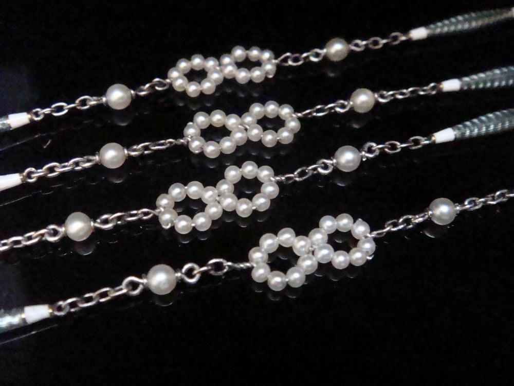 An Edwardian platinum chain detailed with small pearl clusters, single saltwater pearls, and delicate turquoise guilloche enamel links. View VI