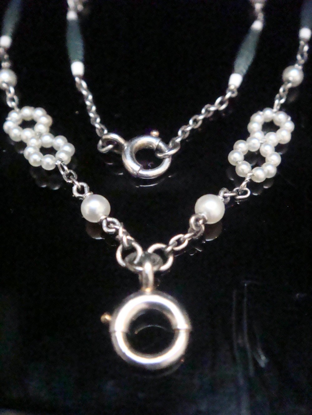 An Edwardian platinum chain detailed with small pearl clusters, single saltwater pearls, and delicate turquoise guilloche enamel links. View VII