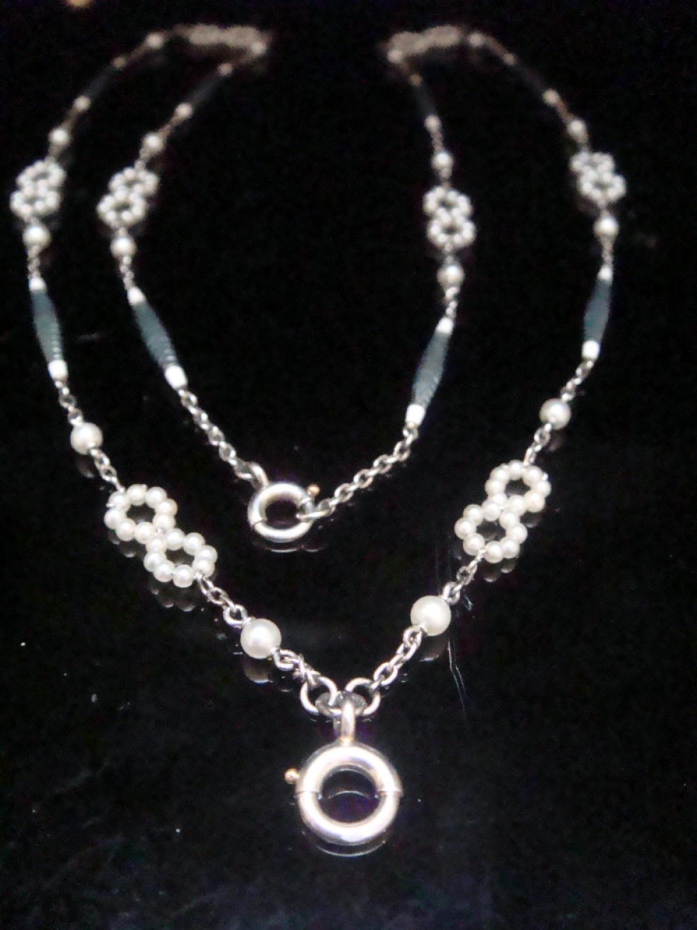 An Edwardian platinum chain detailed with small pearl clusters, single saltwater pearls, and delicate turquoise guilloche enamel links. View VIII