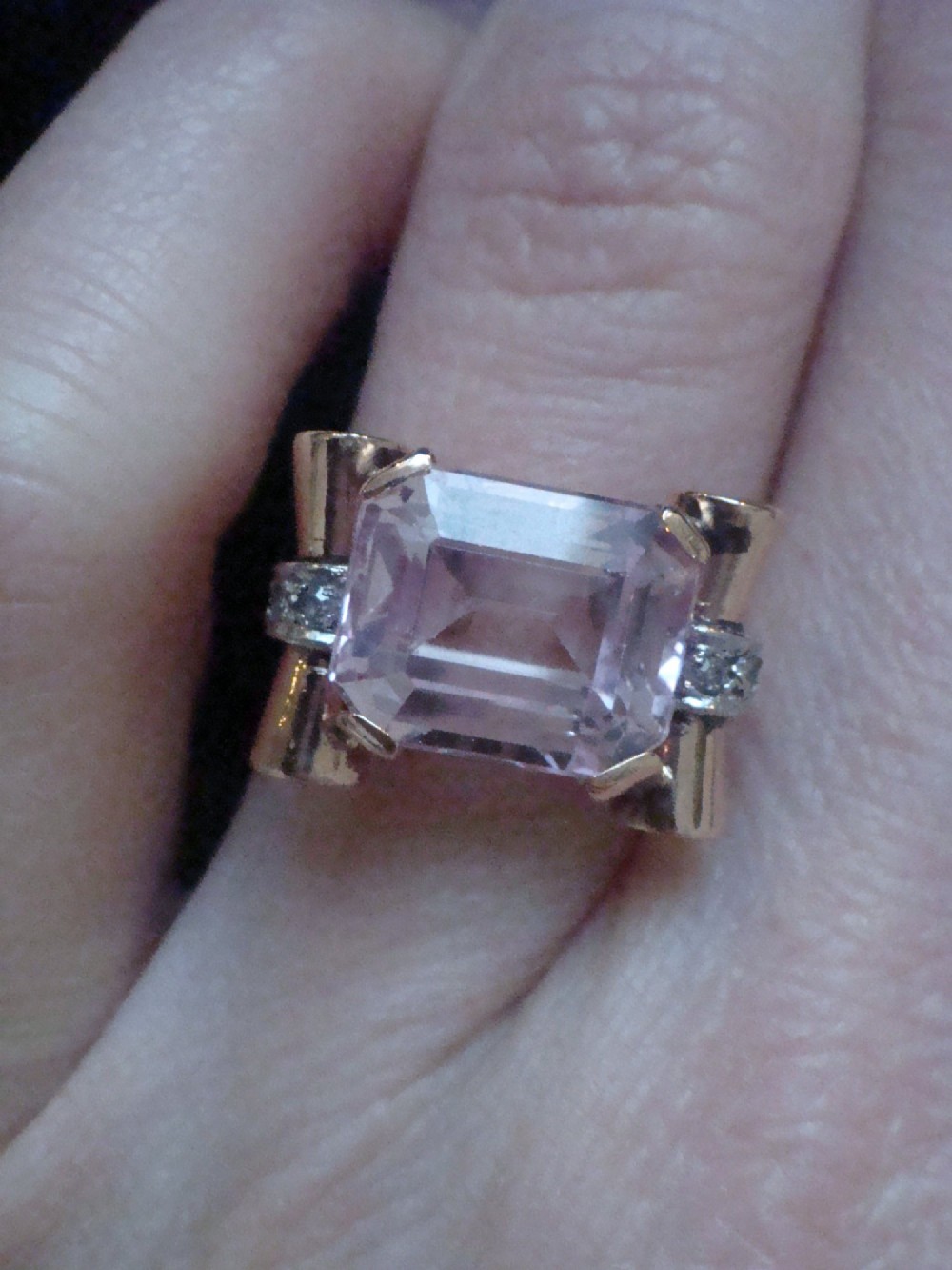 A Retro 18ct gold tank cocktail ring featuring an emerald cut pink kunzite central gemstone flanked by diamond accent bands. View III