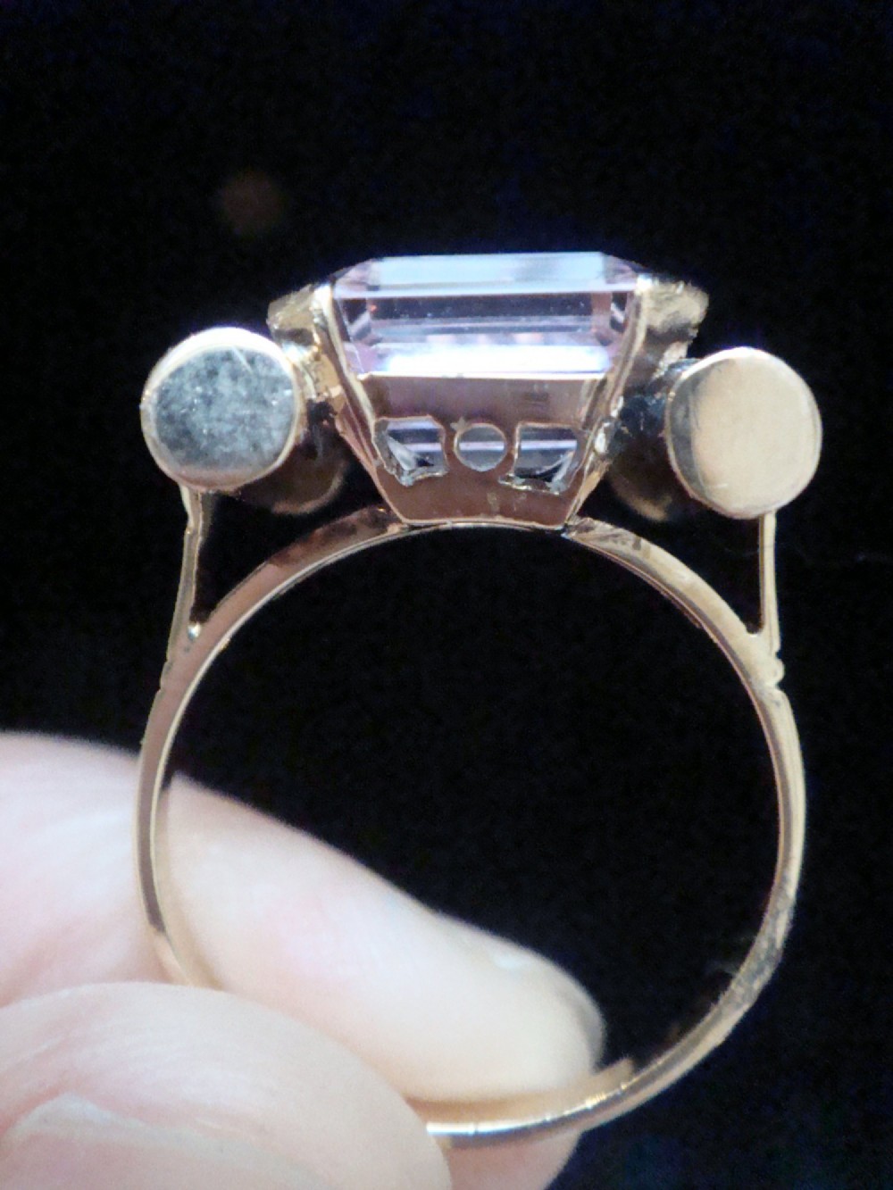 A Retro 18ct gold tank cocktail ring featuring an emerald cut pink kunzite central gemstone flanked by diamond accent bands. View IV