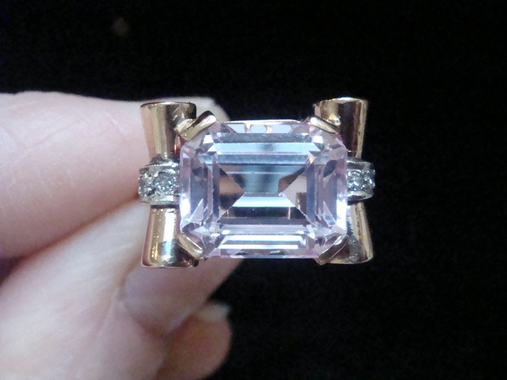 A Retro 18ct gold tank cocktail ring featuring an emerald cut pink kunzite central gemstone flanked by diamond accent bands.