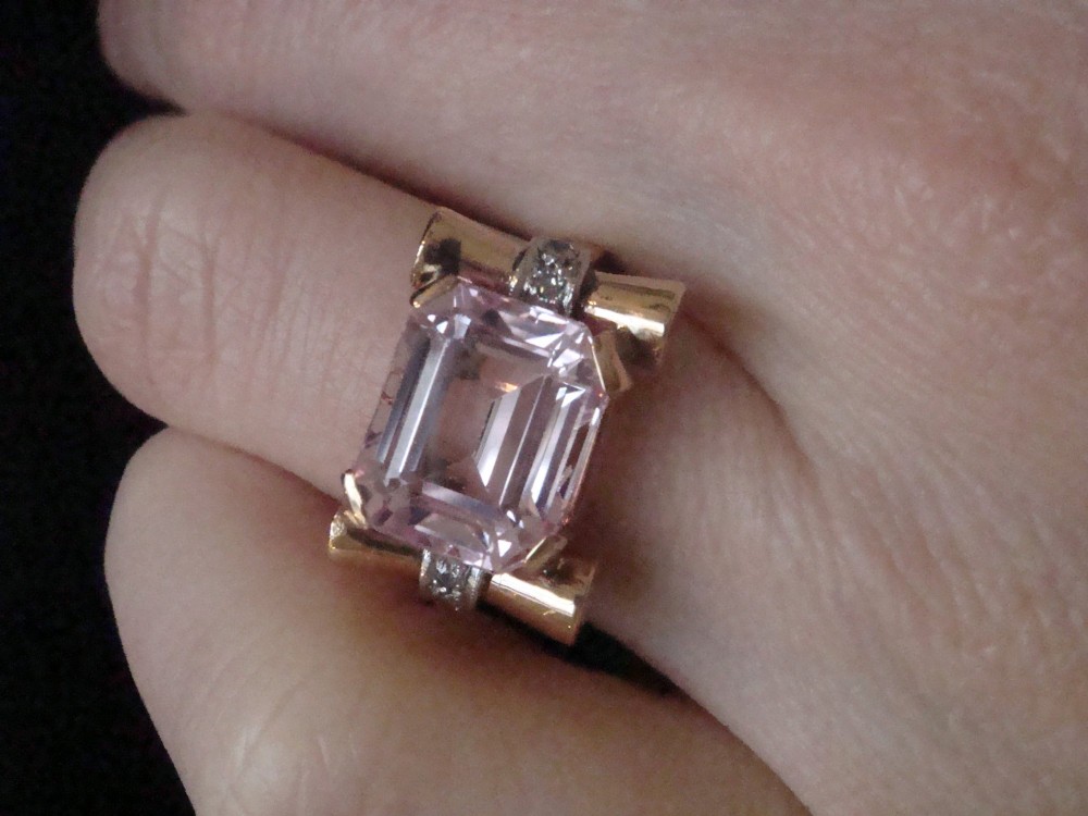 A Retro 18ct gold tank cocktail ring featuring an emerald cut pink kunzite central gemstone flanked by diamond accent bands. View VI