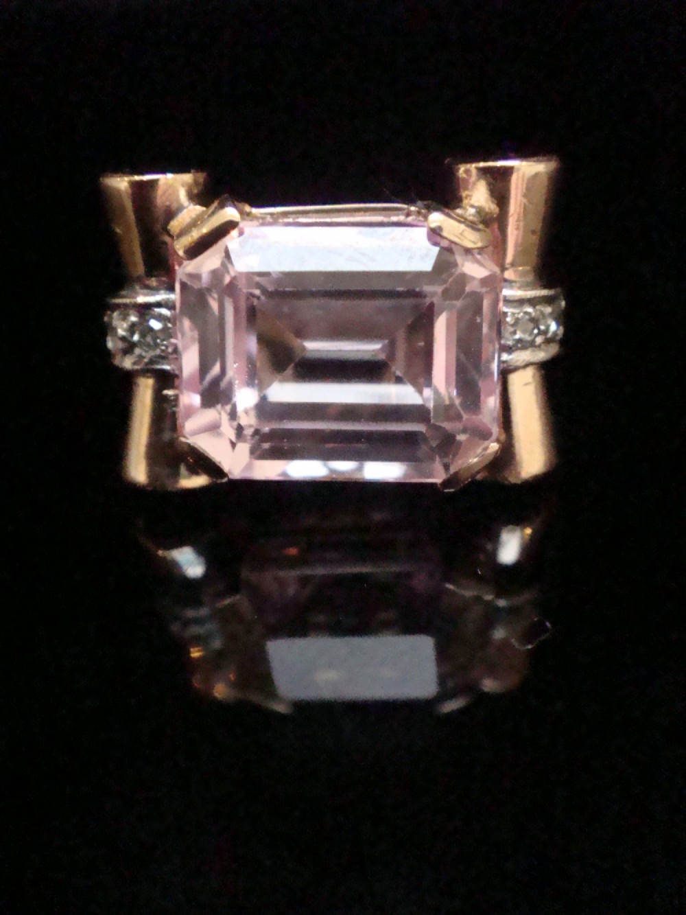 A Retro 18ct gold tank cocktail ring featuring an emerald cut pink kunzite central gemstone flanked by diamond accent bands. View VII