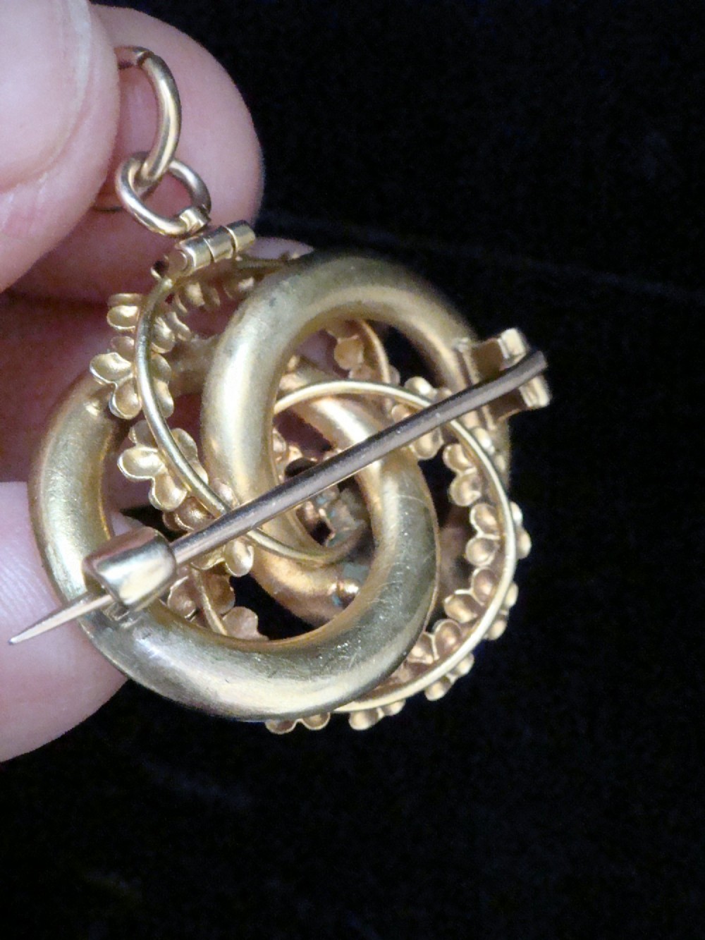Victorian 18ct textured gold lovers knot brooch and pendant featuring light blue enamelled forget-me-not flowers and a central solitaire diamond. View II