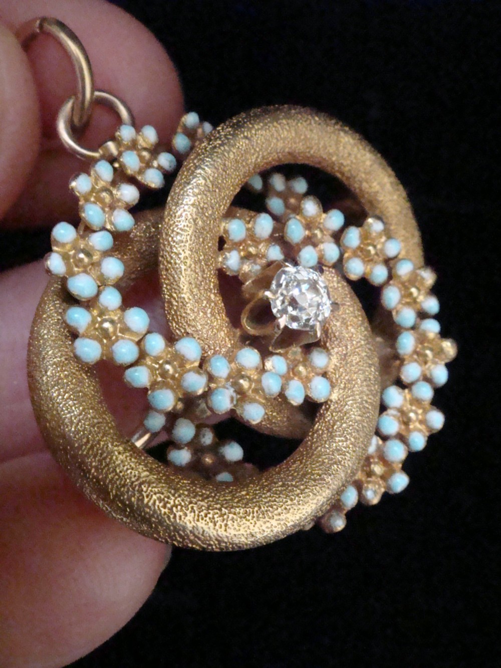 Victorian 18ct textured gold lovers knot brooch and pendant featuring light blue enamelled forget-me-not flowers and a central solitaire diamond. View IV