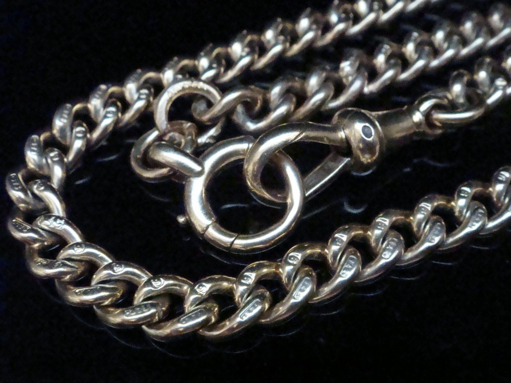 An Edwardian 9ct yellow gold curb link chain featuring a swivel clip clasp and individual hallmark stamps on each link. View II